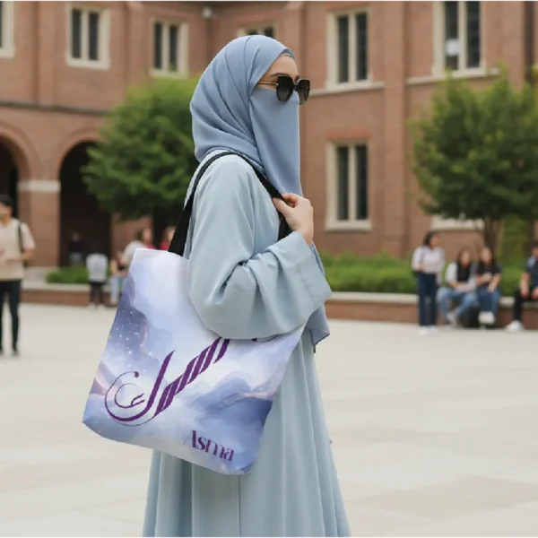 Asma calligraphy tote bag carried over shoulder, lifestyle outdoor mockup