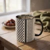 Palestine Keffiyeh two-tone mug with black interior filled with coffee on a wooden table in warm morning light