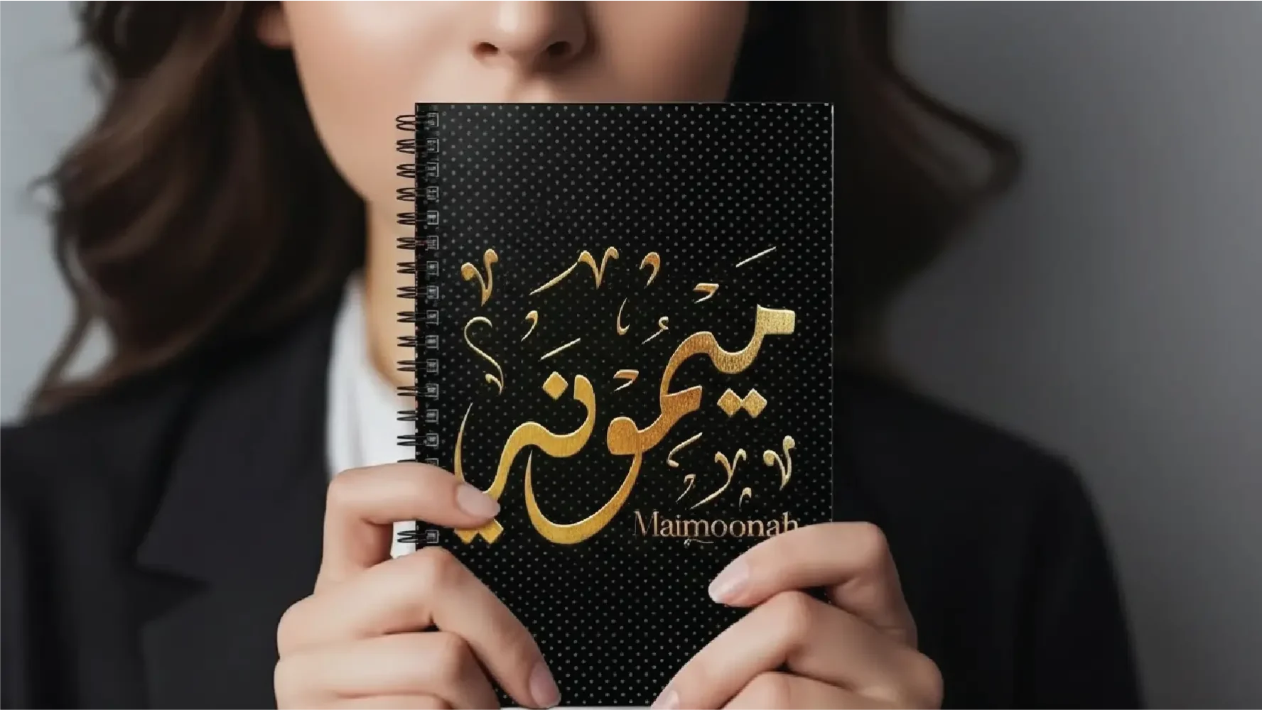 model holding spiral notebook with Maimoonah written in Arabic Diwani Calligraphy - binmahmood