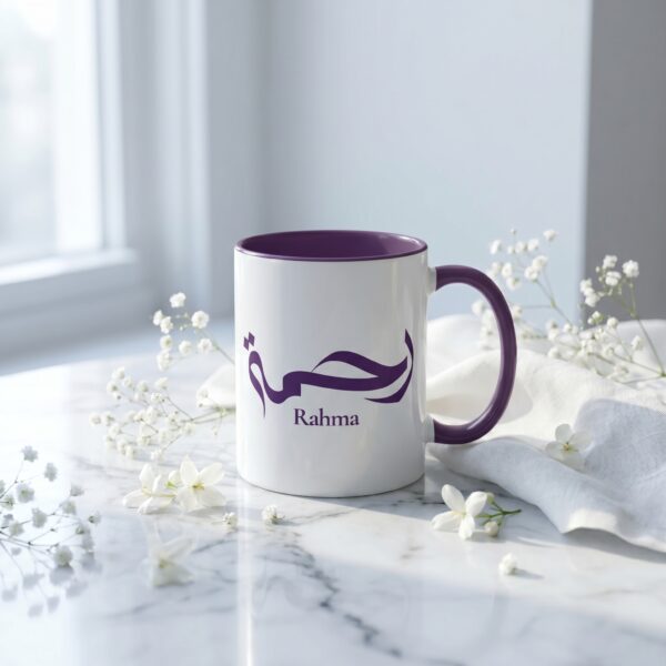 Rahma two tone ceramic mug with calligraphy print, held in hand with coffee steam rising