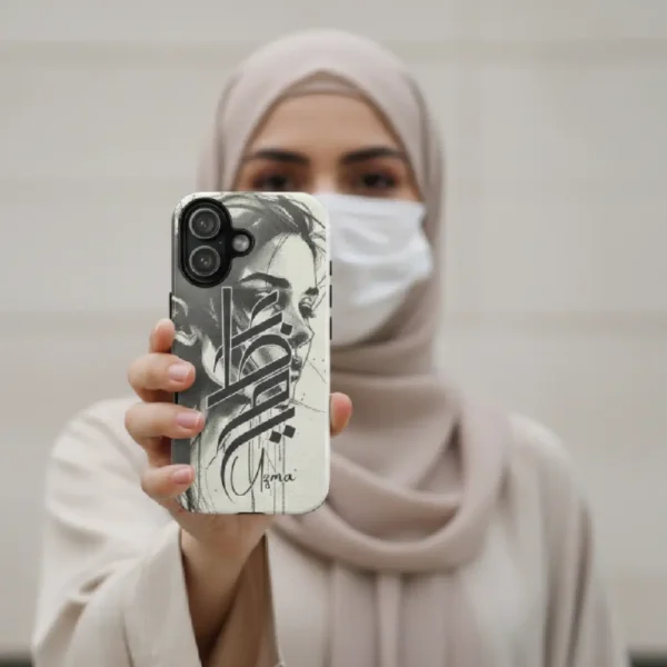 Uzma name in BinMahmood original Arabic fusion calligraphy in grey on a dual-layer protective phone case, styled against an edgy halftone art backdrop — mouse-crafted by BinMahmood