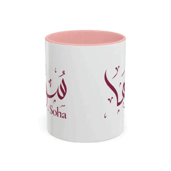Soha name hand-crafted in Al-Wisaam Arabic calligraphy in burgundy ink on an 11oz white ceramic mug with pink two-tone accent — mouse-crafted by BinMahmood