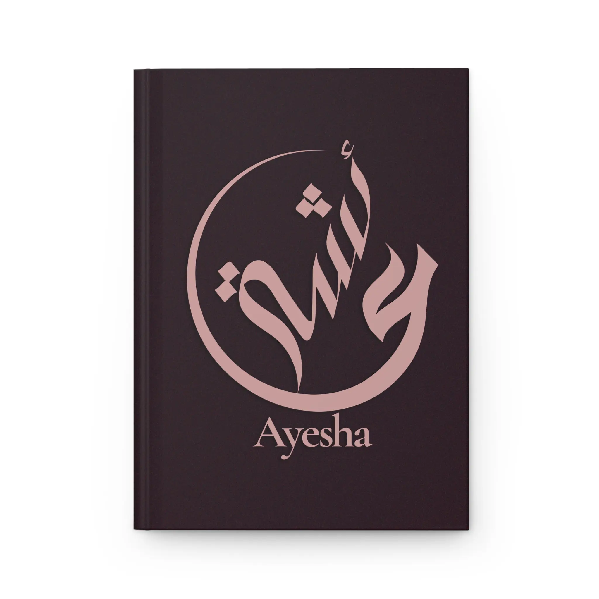 Ayesha name journal cover in plum with muted rose gold Arabic calligraphy, product mockup on white background