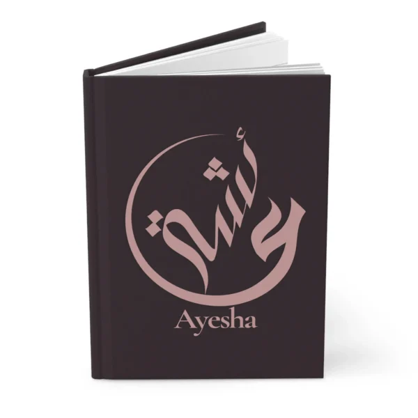 Ayesha name journal cover in plum with muted rose gold Arabic calligraphy, product mockup on white background