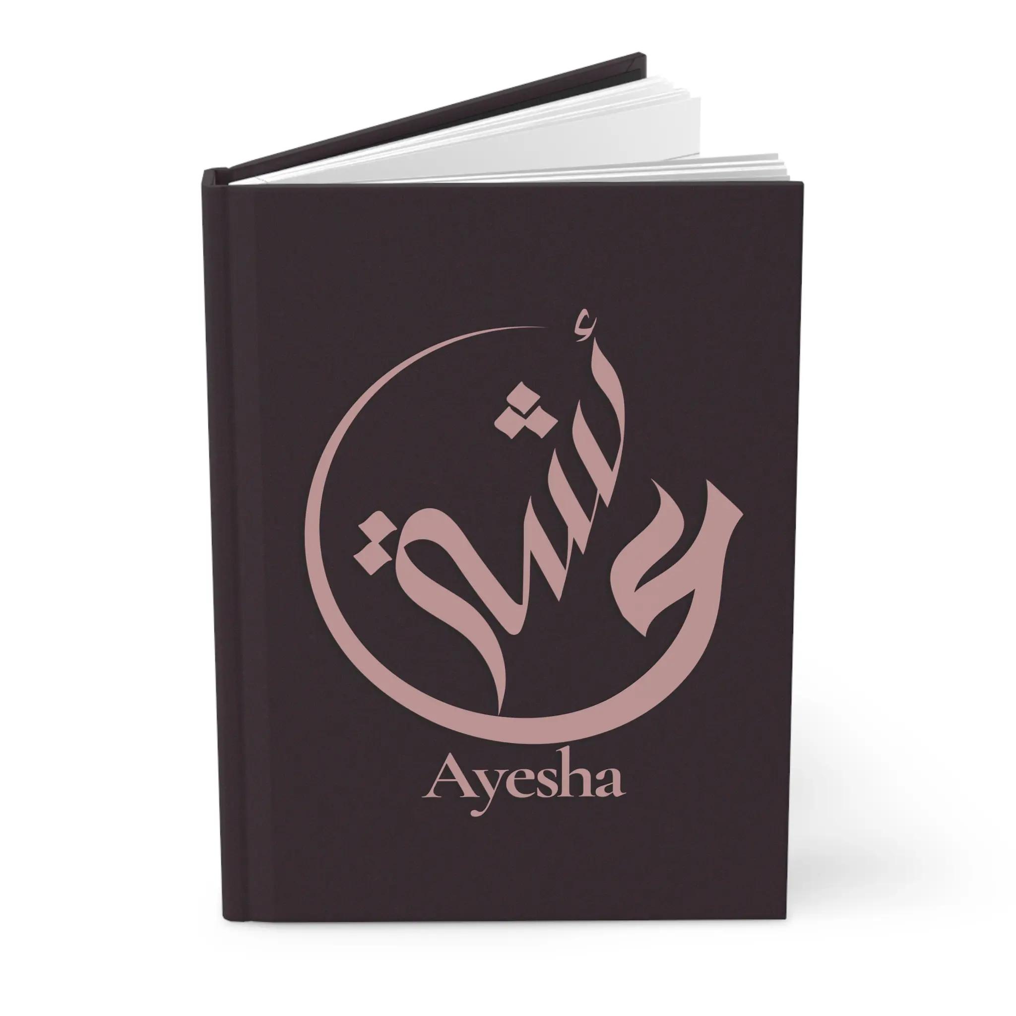 Ayesha name journal cover in plum with muted rose gold Arabic calligraphy, product mockup on white background