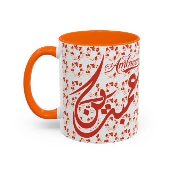 Isolated studio product shot of the Ambreen unique two tone ceramic coffee cup showing a vibrant orange rim and accent handle over a solid white background by BinMahmood.