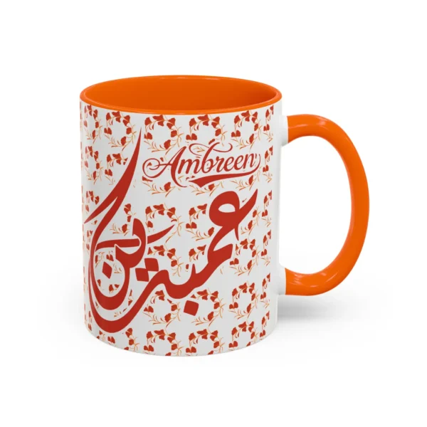 Isolated studio product shot of the Ambreen unique two tone ceramic coffee cup showing a vibrant orange rim and accent handle over a solid white background by BinMahmood.