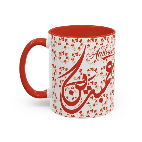 Isolated studio product shot of the Ambreen unique two tone ceramic coffee cup showing a vibrant red rim and accent handle over a solid white background by BinMahmood.