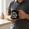 Product photoshoot of Ammar Arabic calligraphy black mug by binmahmood held in hands by a male model wearing a polo shirt