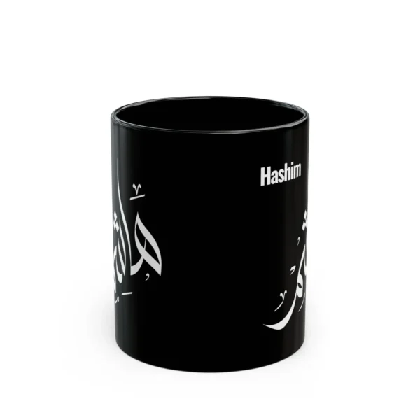 Personalized black ceramic mug with the name Hashim in Arabic calligraphy and English lettering, shown on a plain white background.