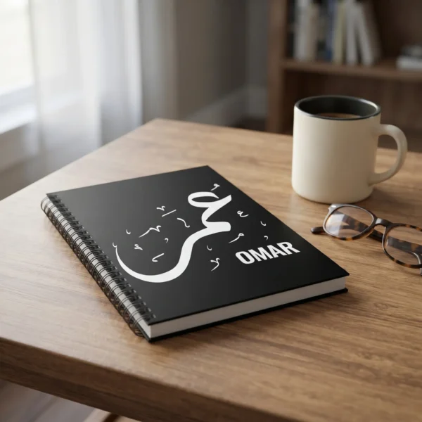 Omar personalized black coffee mug with Arabic calligraphy, styled on a wooden desk