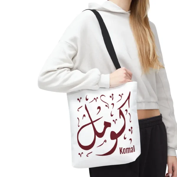A lifestyle model holding the Komal personalised Islamic gift tote bag over her shoulder to showcase aesthetic fit and real world size by BinMahmood.