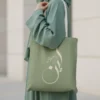 Personalized Leen Arabic Sunbuli Calligraphy Tote Bag in Dusty Sage Green with Warm Cream Script, Front View.