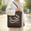 Raha Arabic Al-Wissam Calligraphy Espresso Linen Tote Bag by BinMahmood