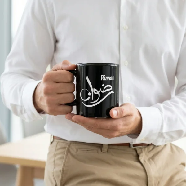 Product photoshoot of a male model holding Rizwan Arabic Fusion Calligraphy Black Mug - BinMahmood