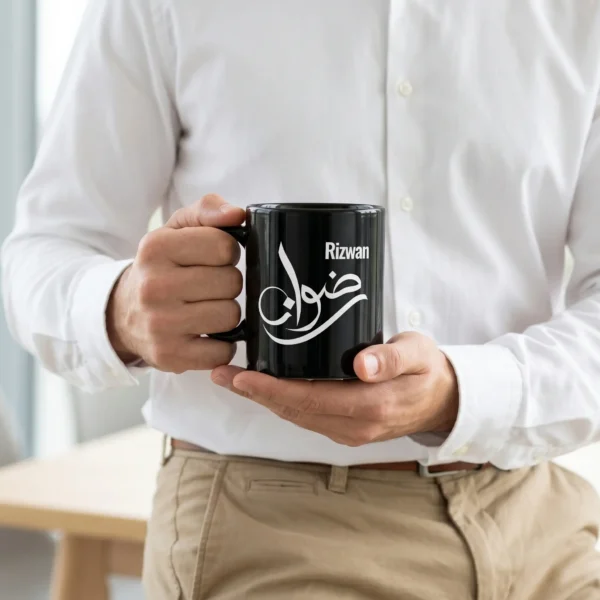 Rizwan personalized black coffee mug with Arabic calligraphy, styled on a wooden desk