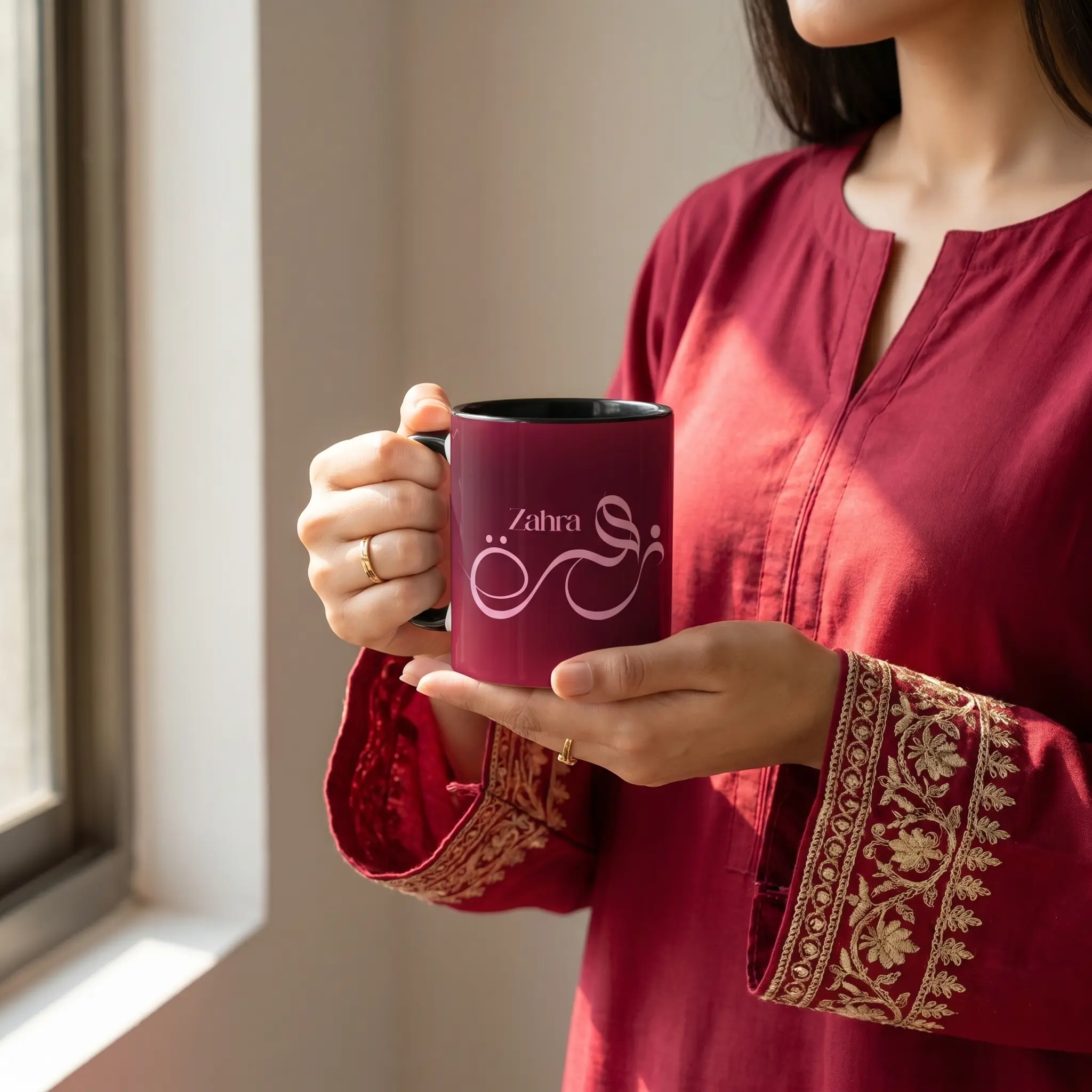 Model showing Zahra tailored Arabic name two-tone coffee mug vibrant colored rim and handle with premium digital script calligraphy by BinMahmood.
