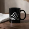 Zaid personalized Arabic calligraphy black mug on a dark wooden table in bright natural light.