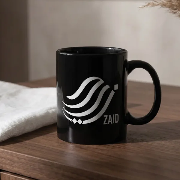 Zaid personalized Arabic calligraphy black mug on a dark wooden table in bright natural light.
